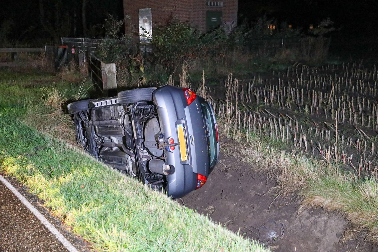 Auto belandt op zijkant in de sloot