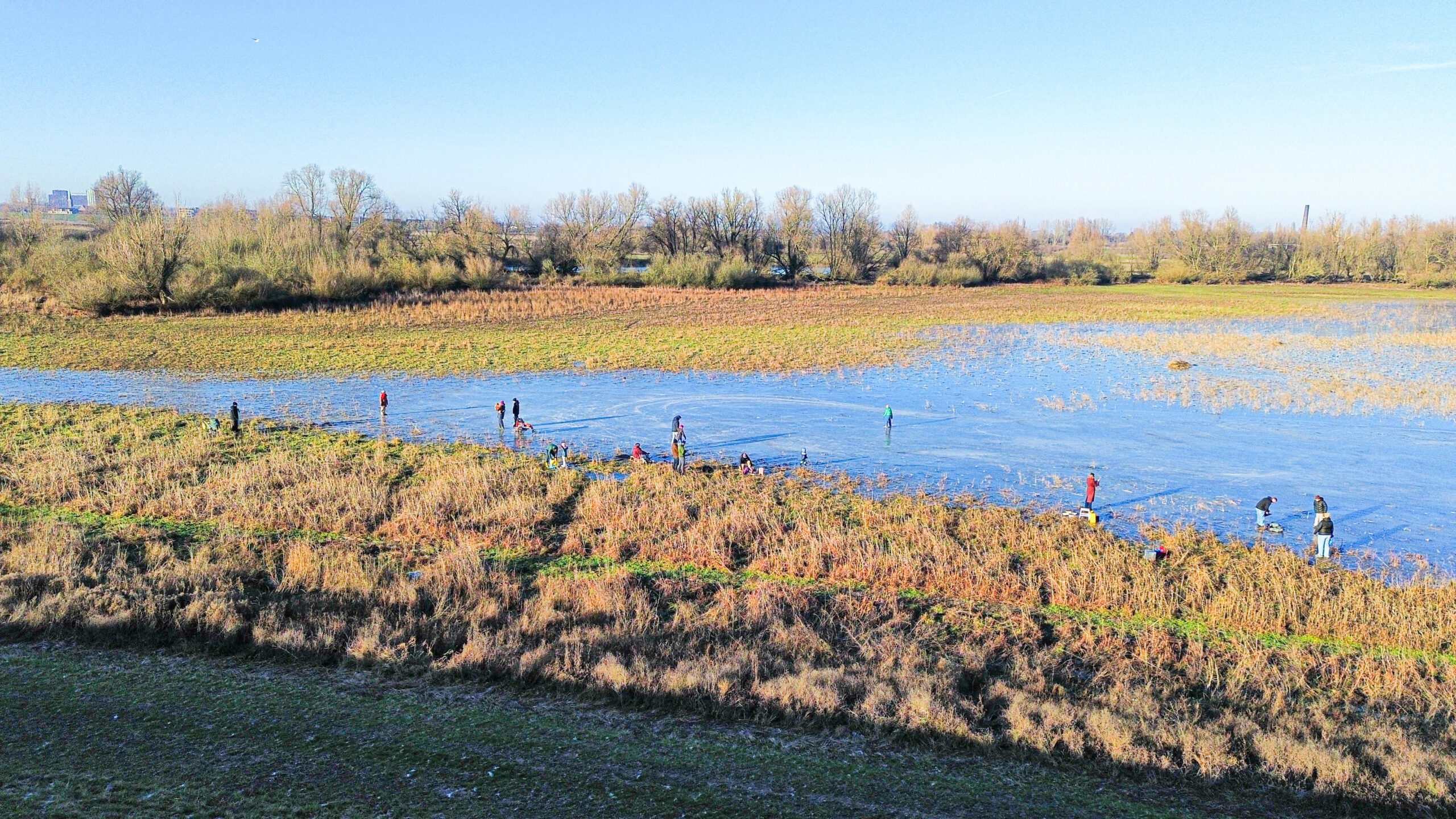 Gezellige drukte op natuurijs tijdens schaatsen op tweede kerstdag