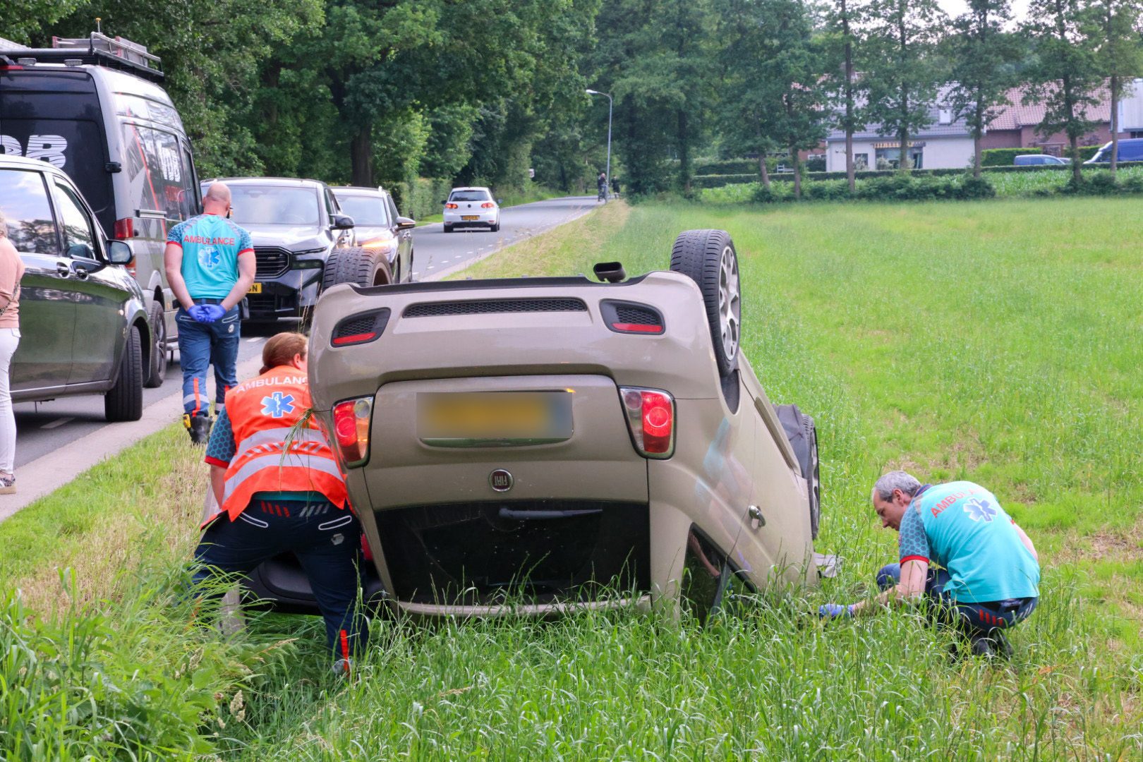 Auto belandt op de kop in weiland na botsing