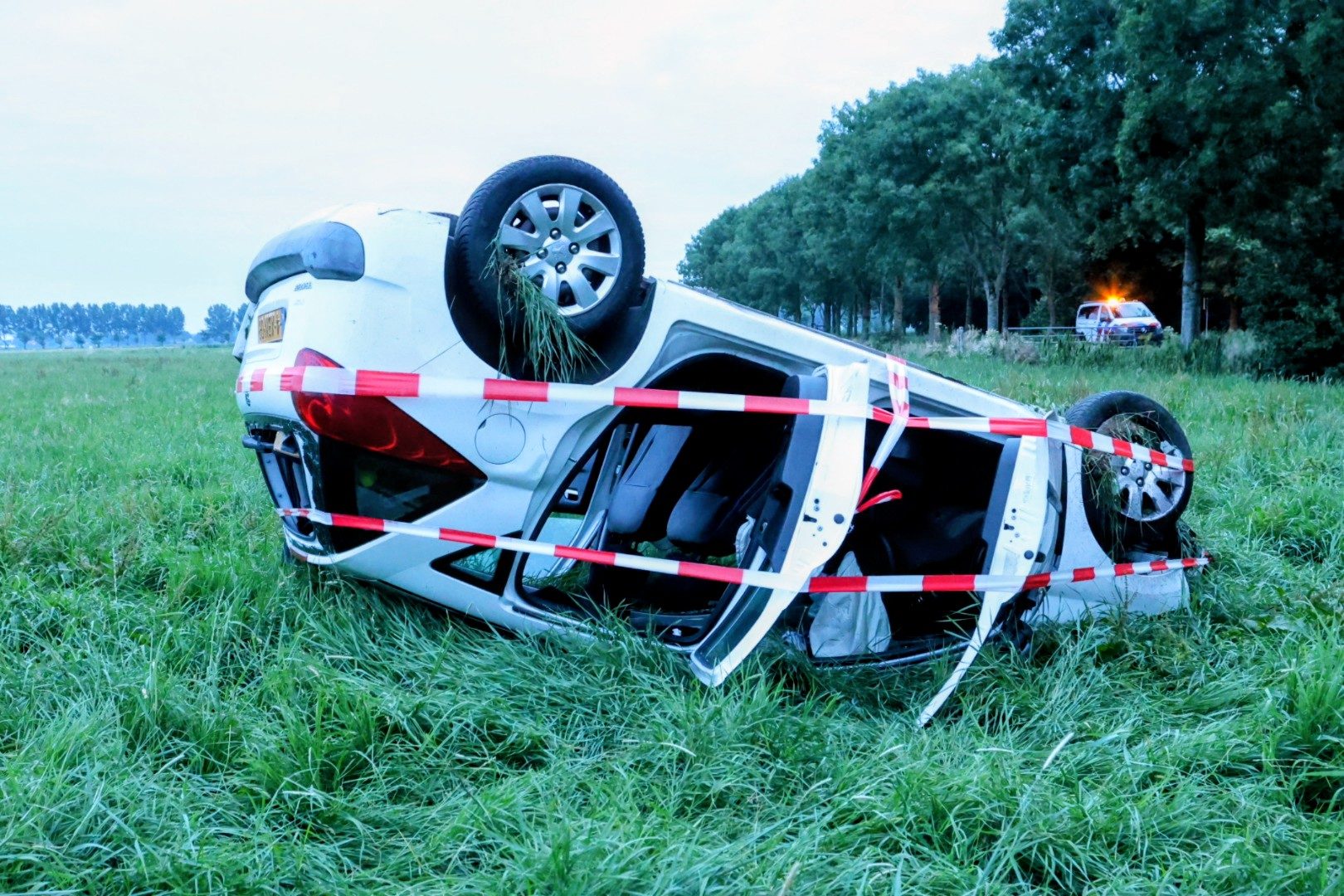Auto op z'n kop in weiland in Herwijnen, bestuurder spoorloos